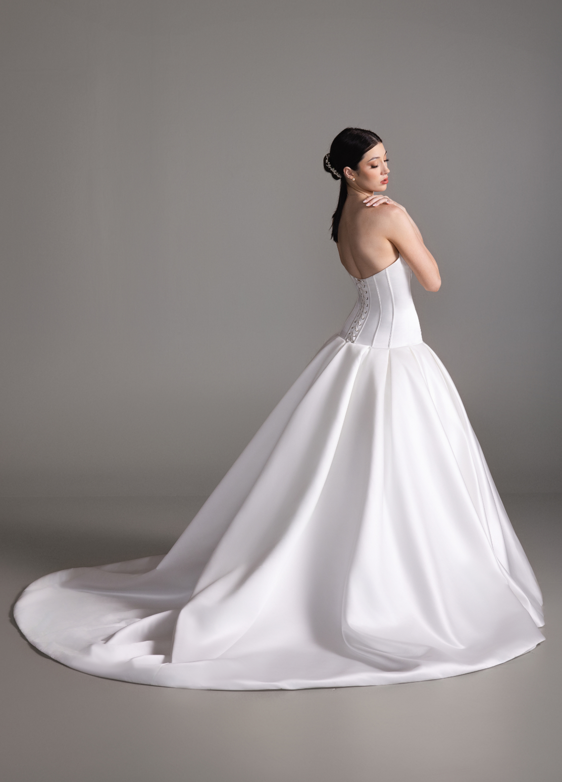 BLANCA bridal gown back view showcasing box-pleated skirt and chapel train