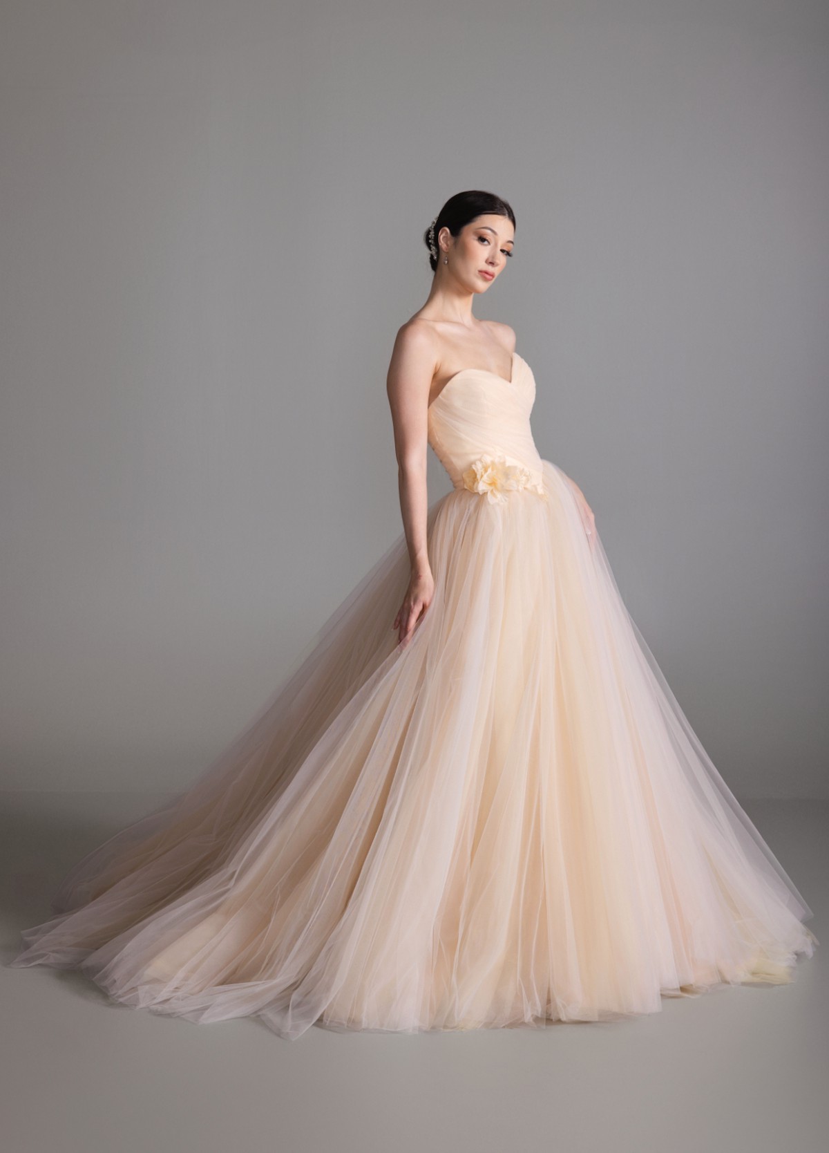 BLOOM sherbet tulle ball gown with sculpted basque waist and floral corsage