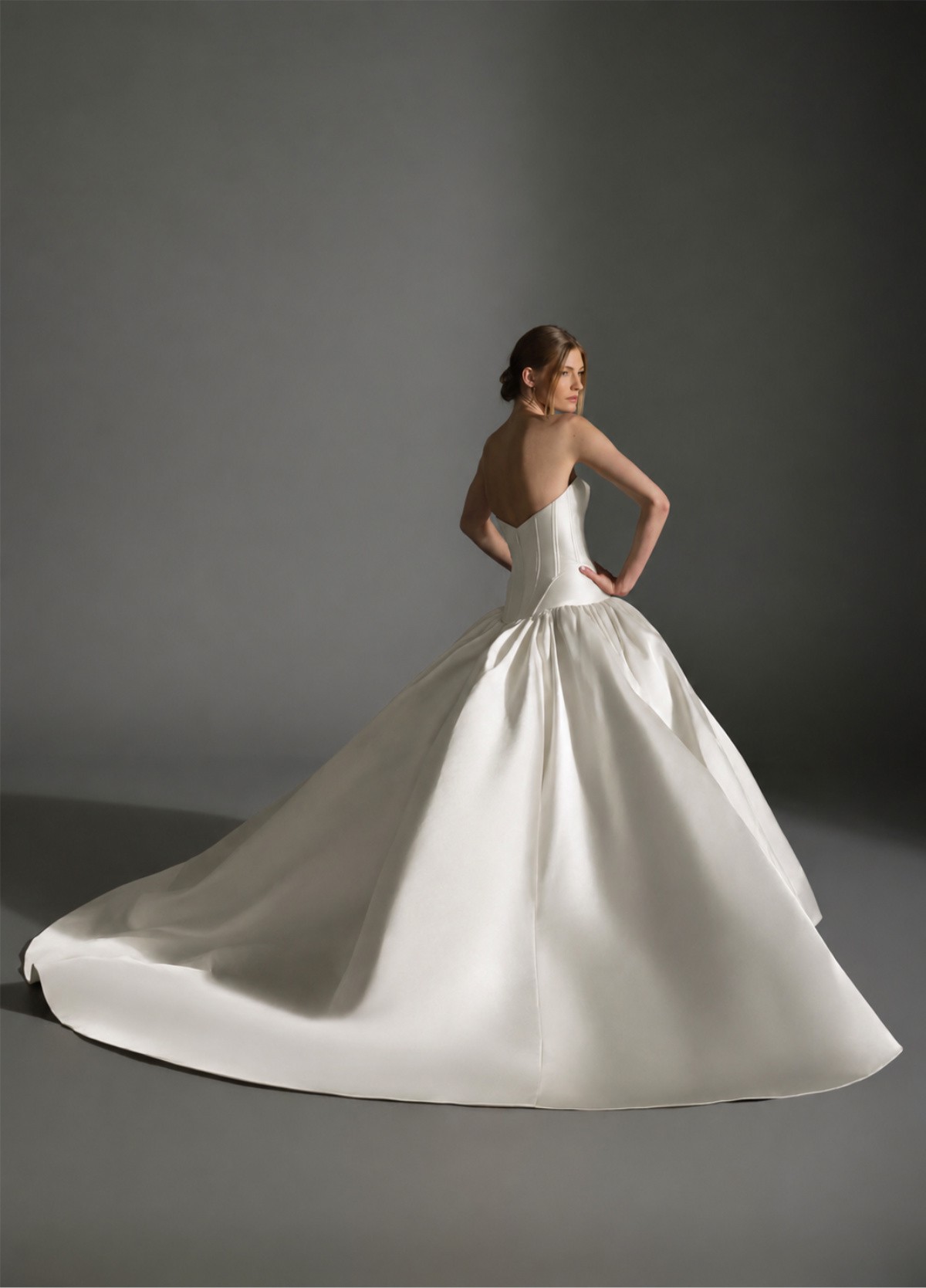 AKARI bridal gown back view showcasing sculptural volume and chapel train drama