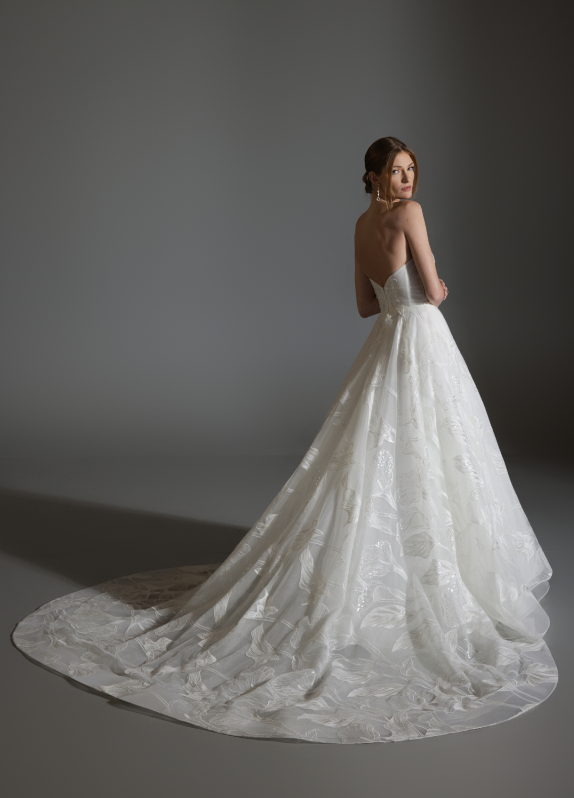 ALI bridal gown back view showcasing full circular skirt and chapel train elegance