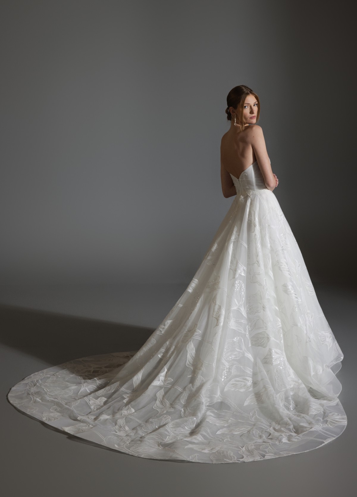 ALI bridal gown back view showcasing full circular skirt and chapel train elegance