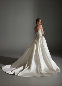 ALICIA bridal dress back view showcasing sculpted skirt and chapel train flow