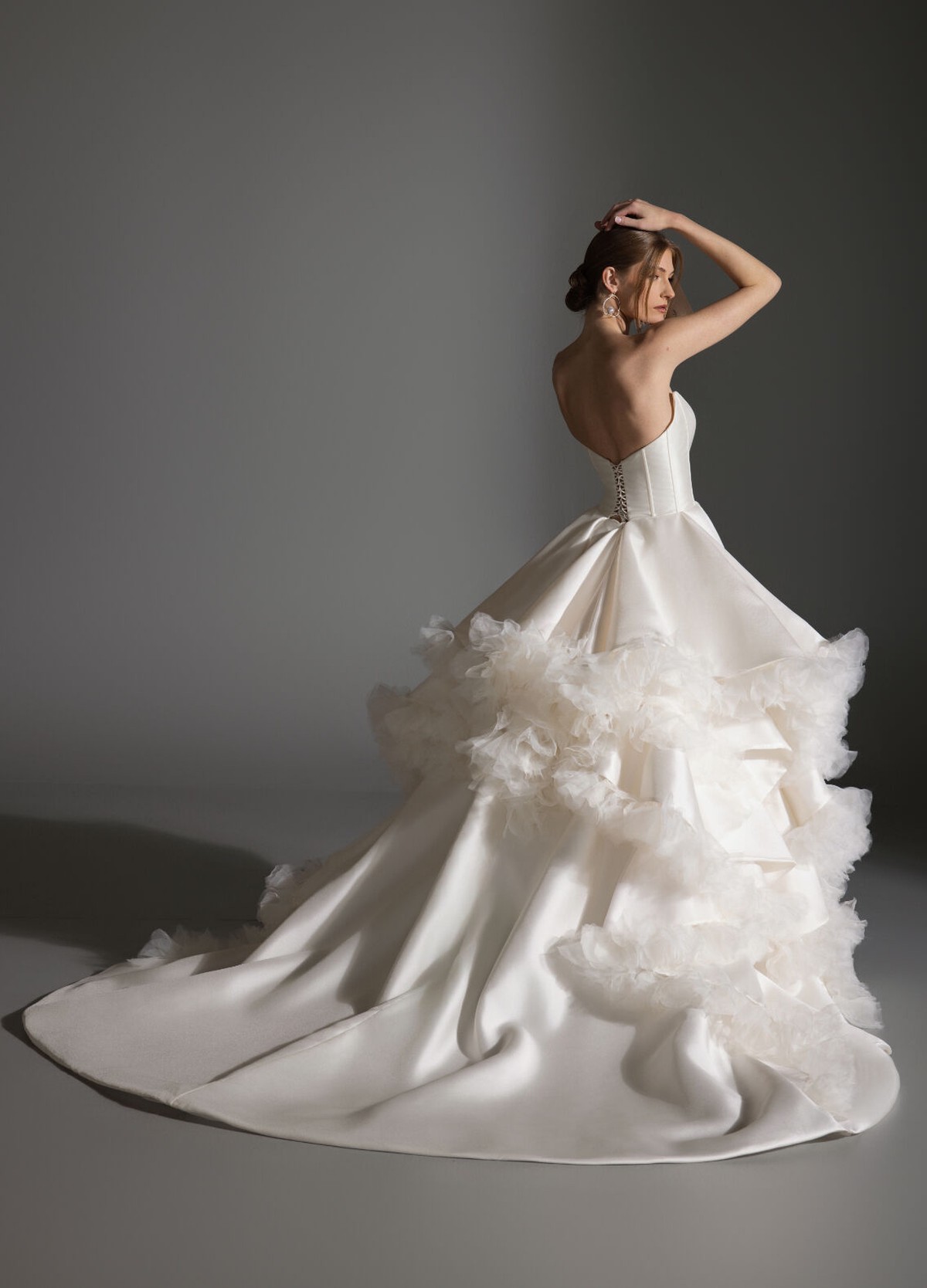 APRIL bridal dress back view featuring lace-up detail and cascading petal embellishments