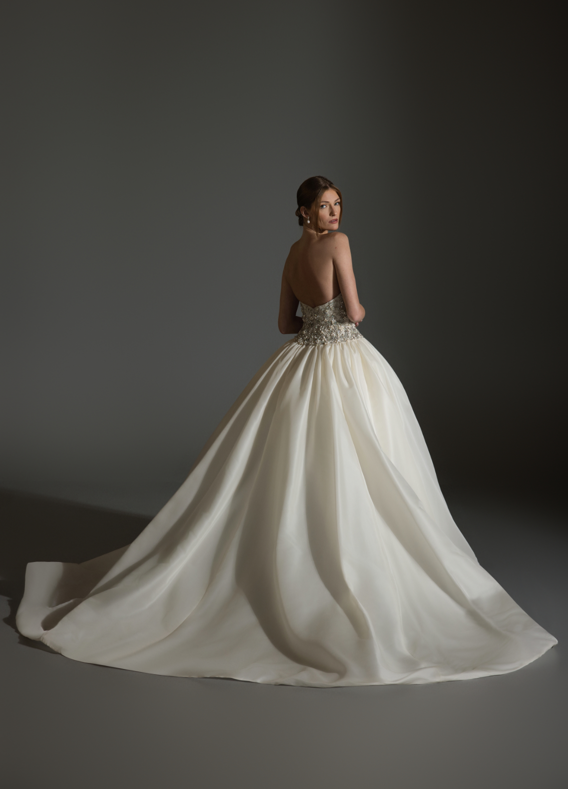 ASPEN bridal gown back view with gathered skirt flowing into chapel train elegance