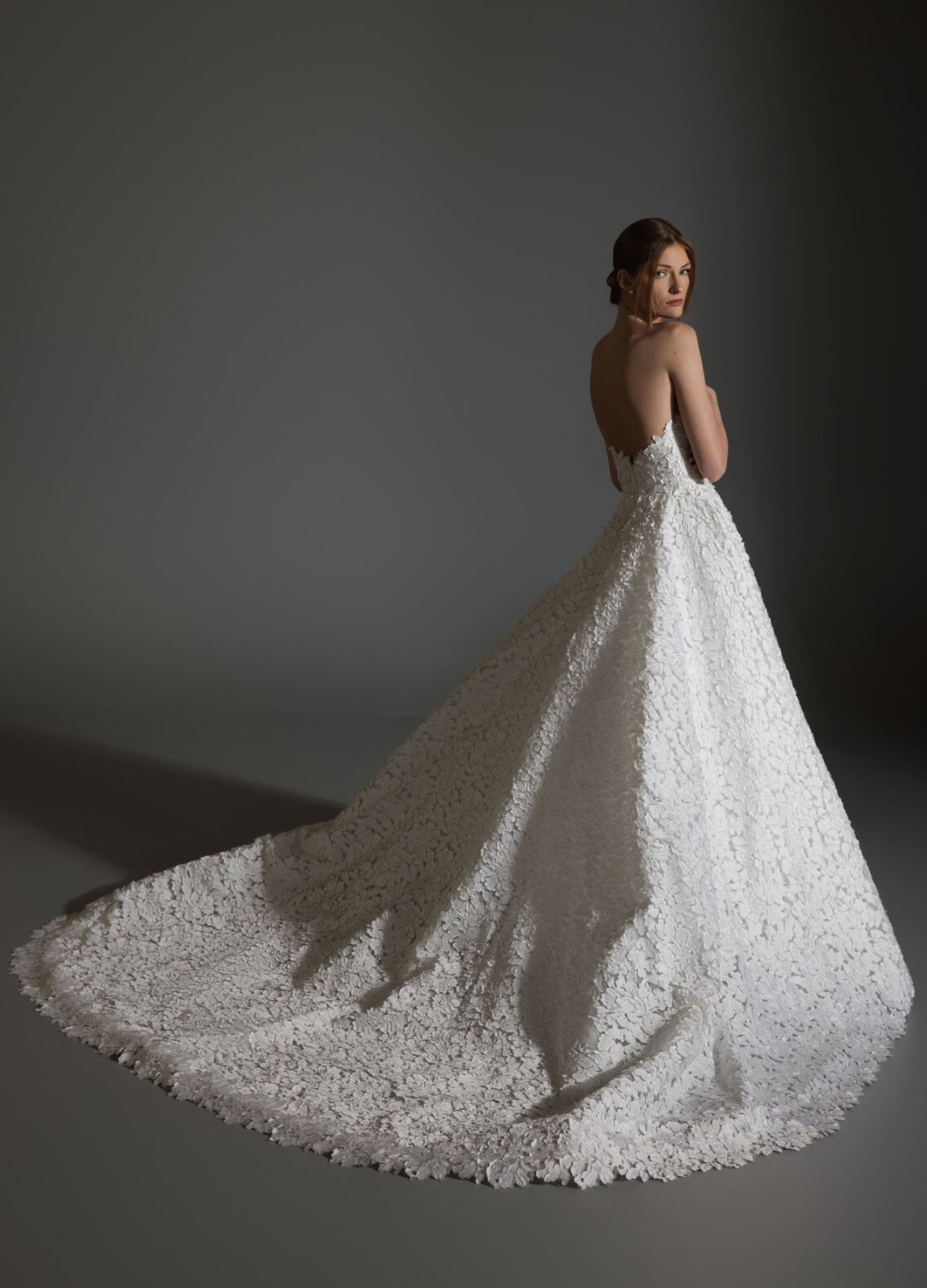 AVERY bridal gown back view showcasing full circular skirt and chapel train flow